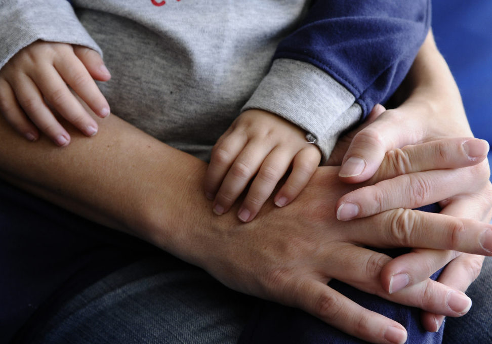 Adult holding hands with a child